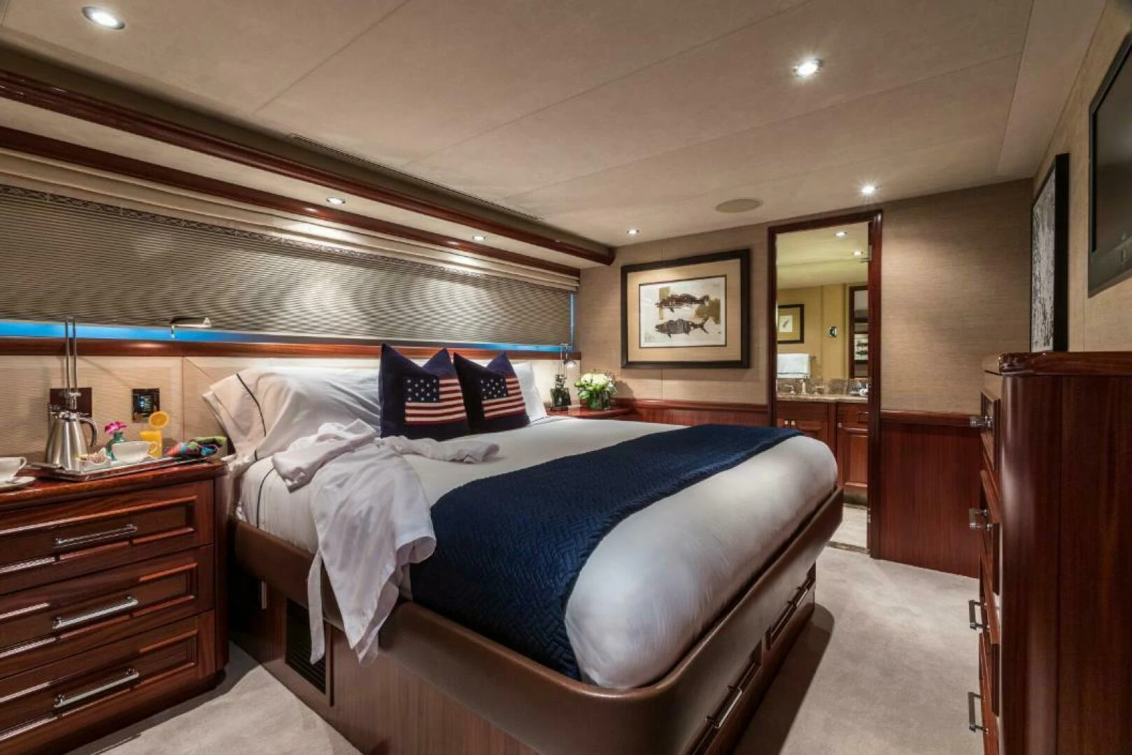 a bedroom with a bed and a dresser aboard ALL INN Yacht for Sale