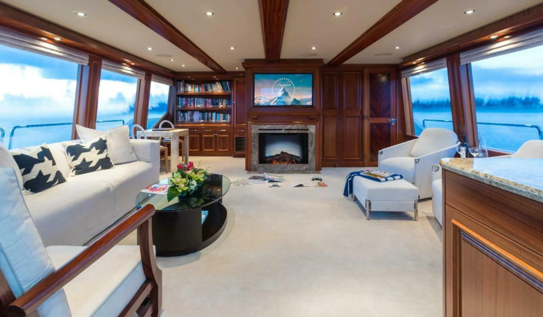 a living room with a fireplace aboard ALL INN Yacht for Sale