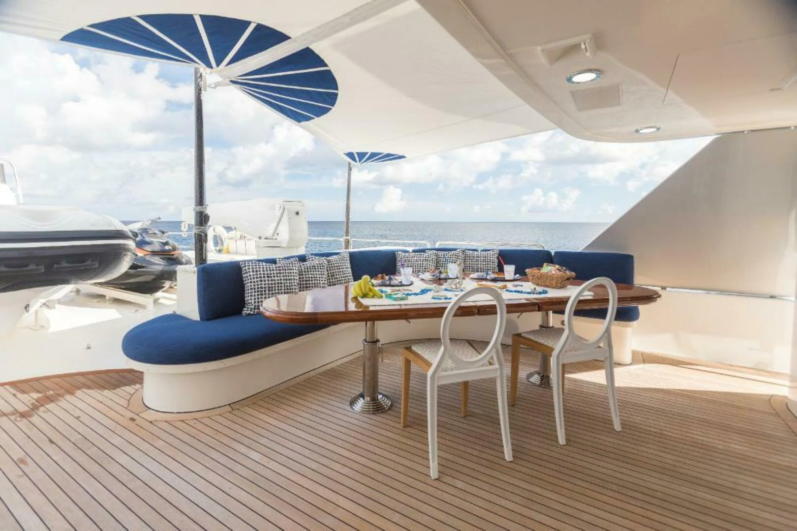 a patio with a table and chairs aboard ALL INN Yacht for Sale
