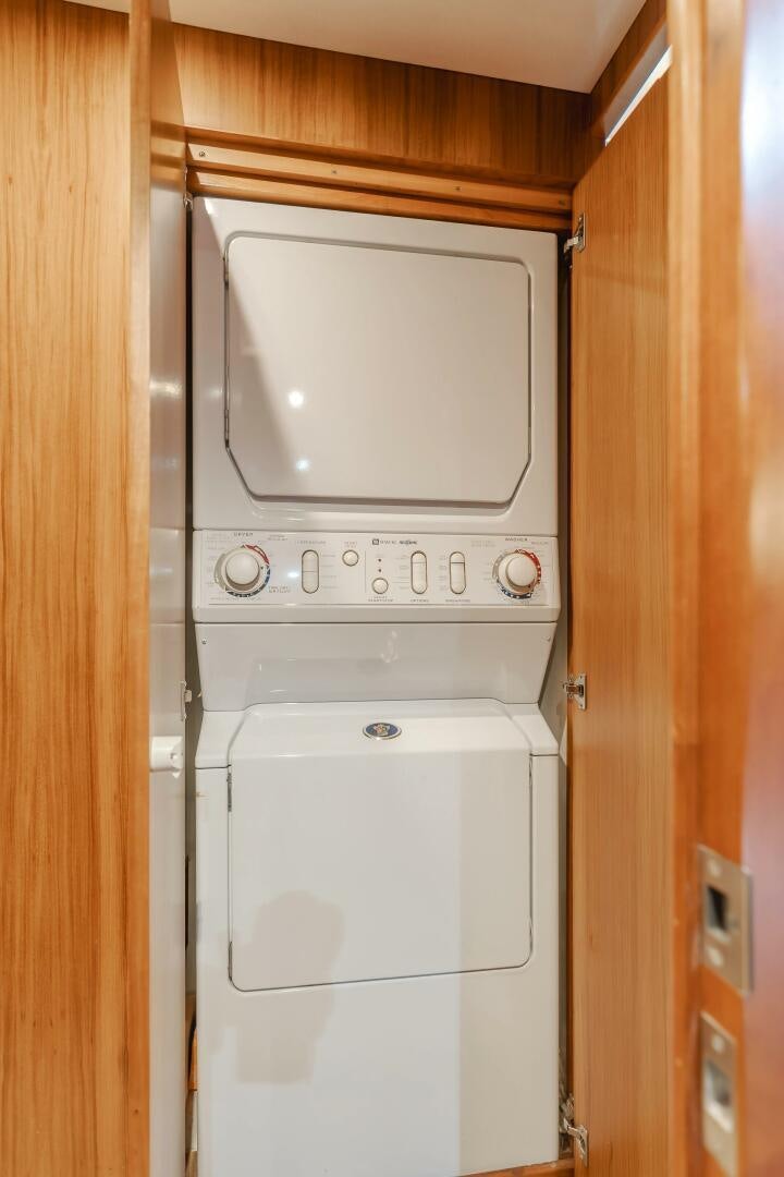 a white appliance in a wooden room aboard MONEY CAT Yacht for Sale