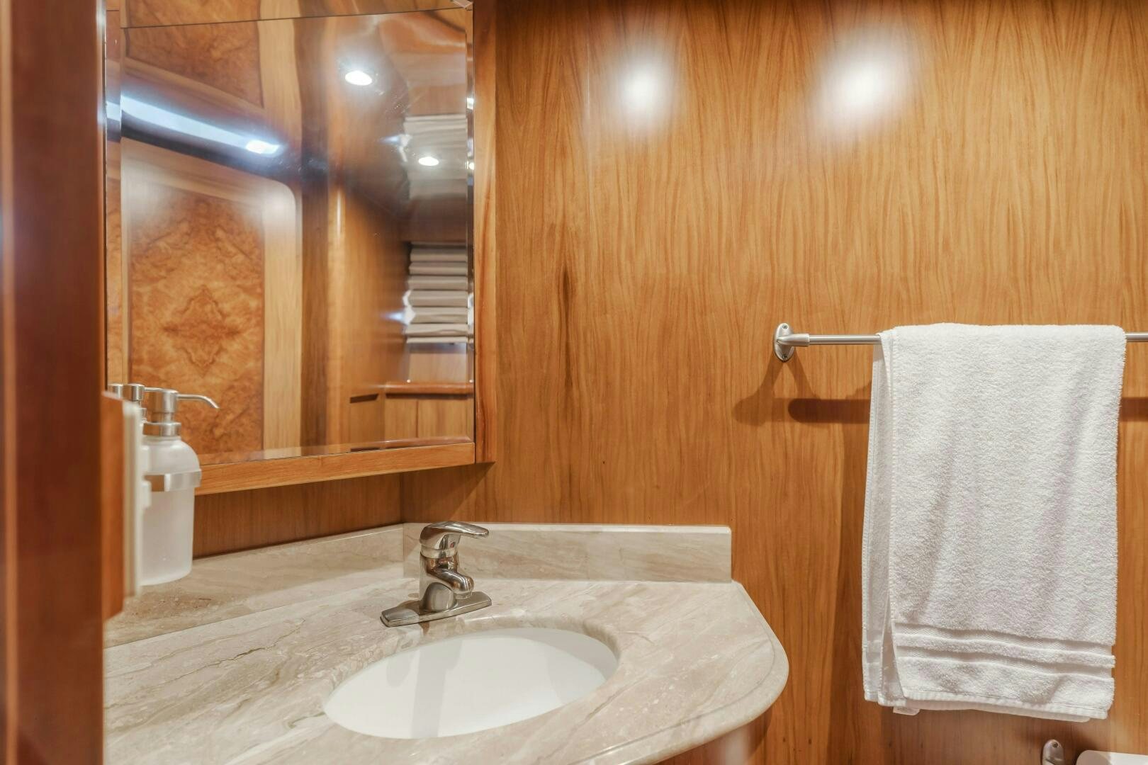 a bathroom with a sink and towels aboard MONEY CAT Yacht for Sale