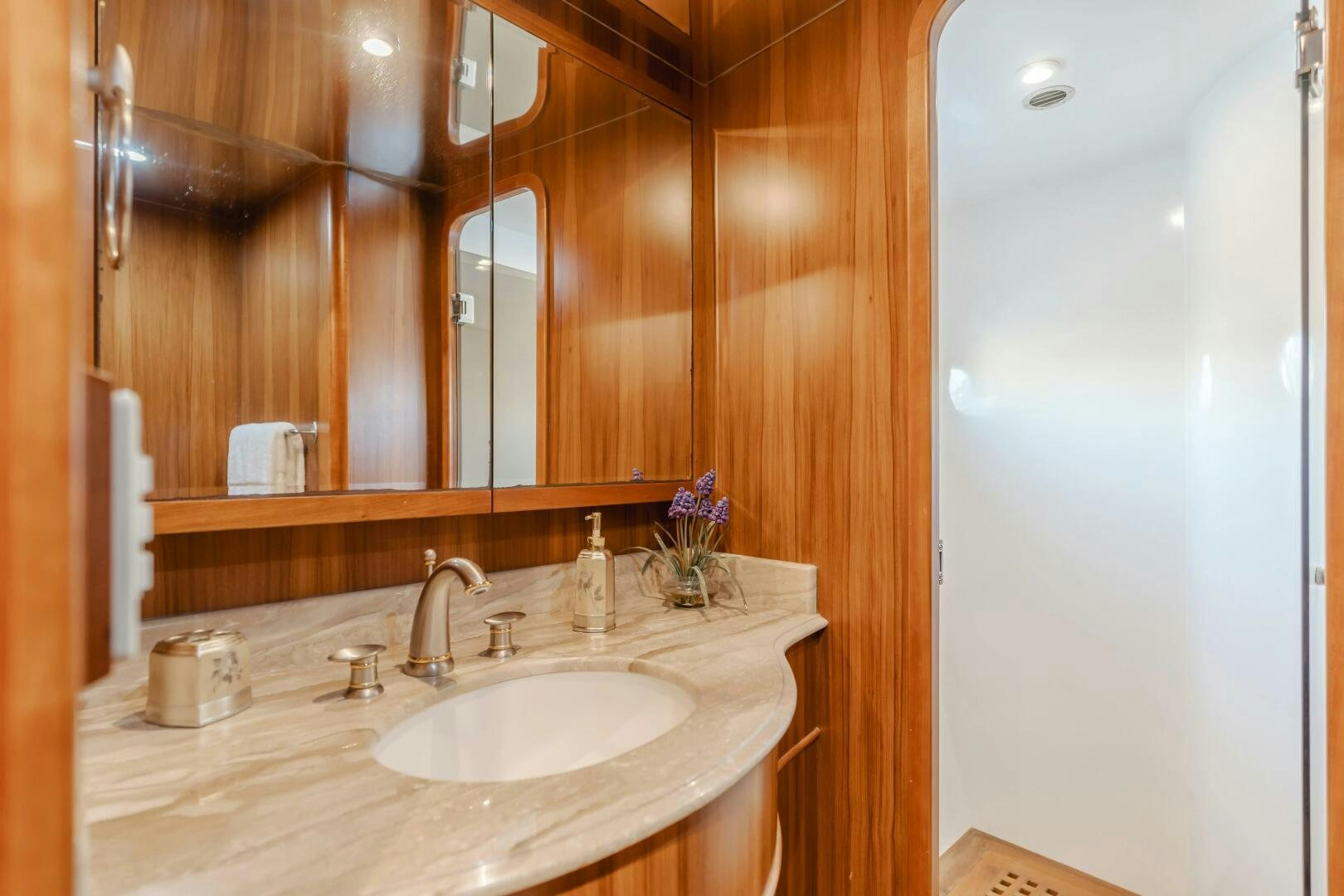 a bathroom with a sink and a mirror aboard MONEY CAT Yacht for Sale