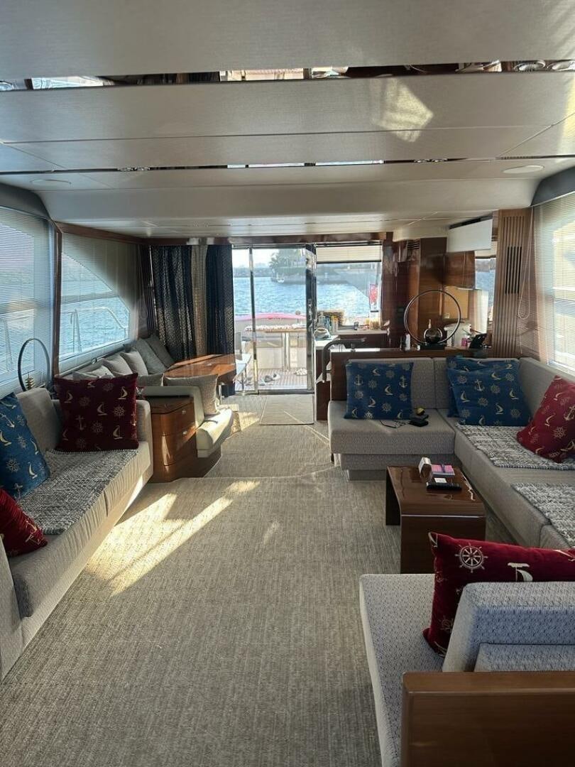 a living room with a large window aboard VISTA III Yacht for Sale