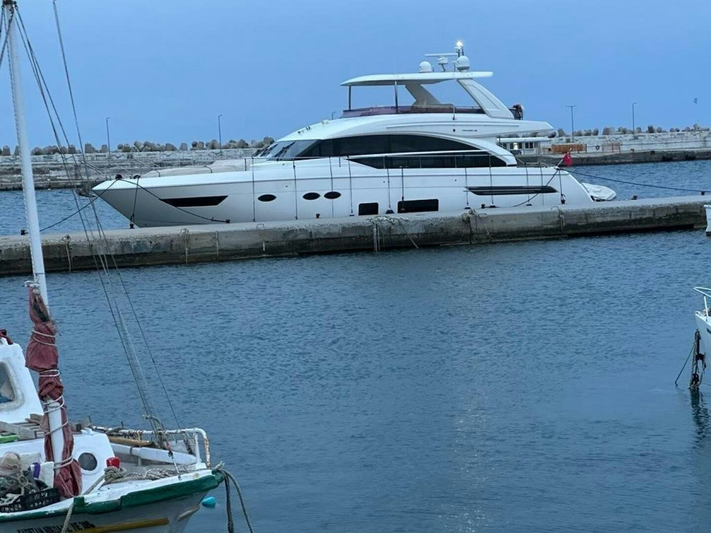 a boat docked at a pier aboard VISTA III Yacht for Sale