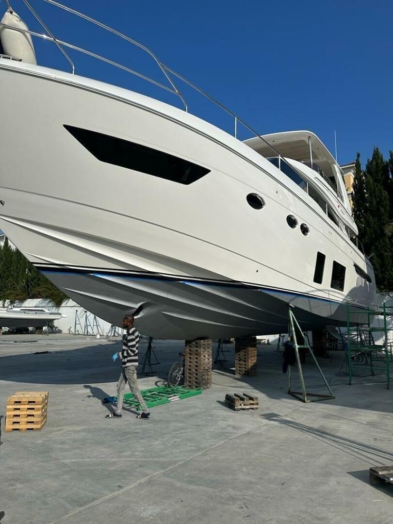 a person standing next to a large white plane aboard VISTA III Yacht for Sale