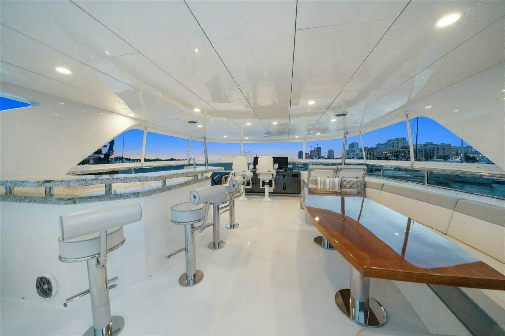 a room with tables and chairs aboard CAROL ELAINE Yacht for Sale