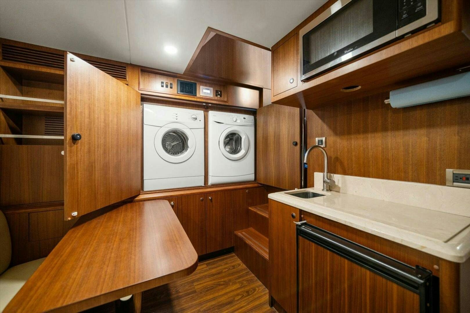 a kitchen with wooden cabinets aboard CAROL ELAINE Yacht for Sale