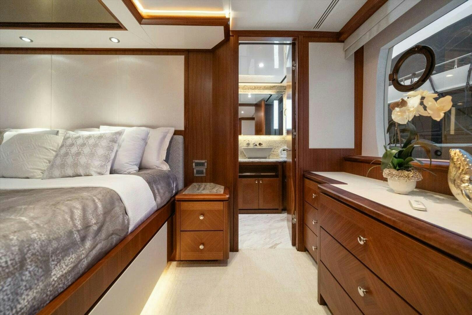 a bedroom with a bed and a mirror aboard CAROL ELAINE Yacht for Sale