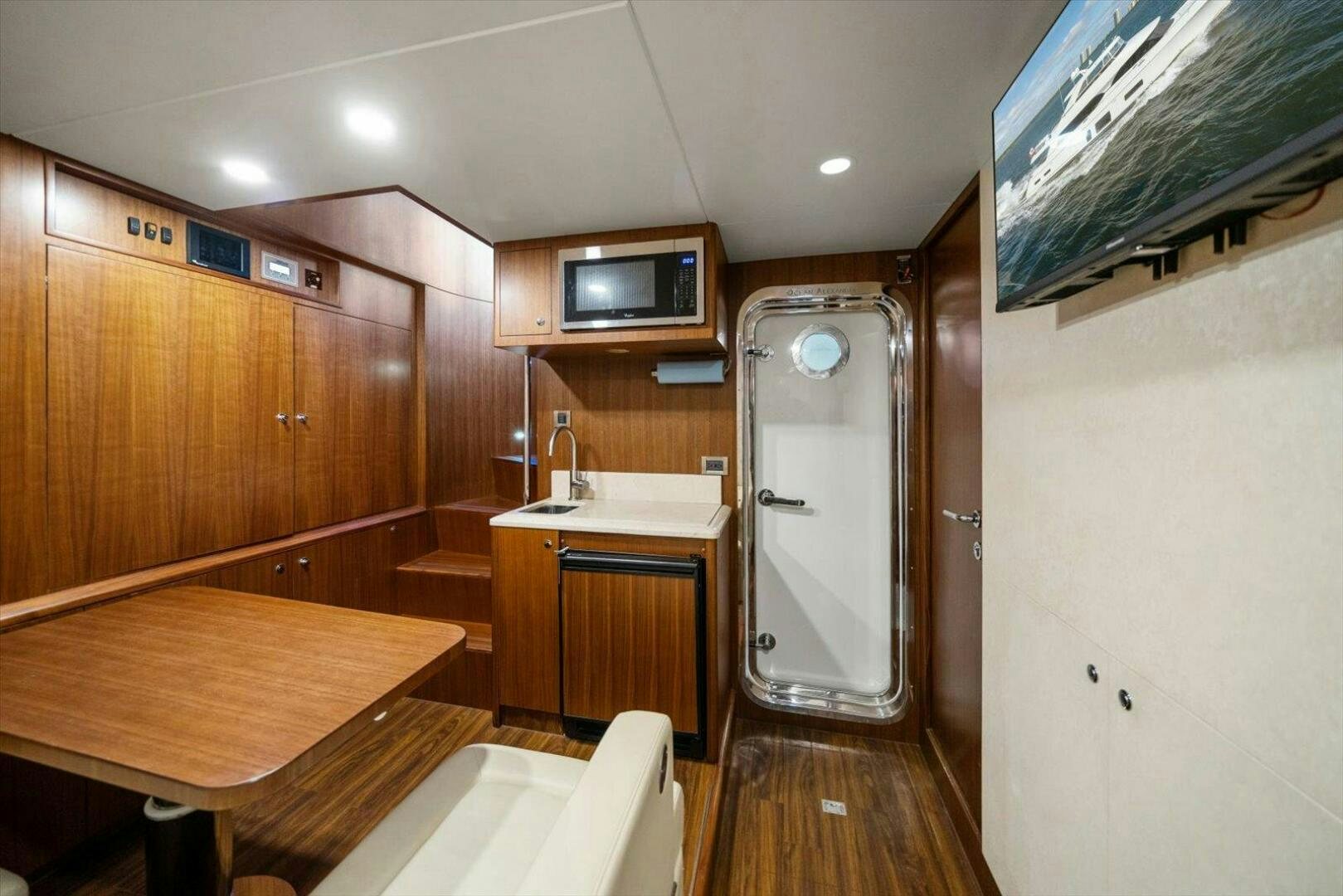 a kitchen with a table and tv aboard CAROL ELAINE Yacht for Sale