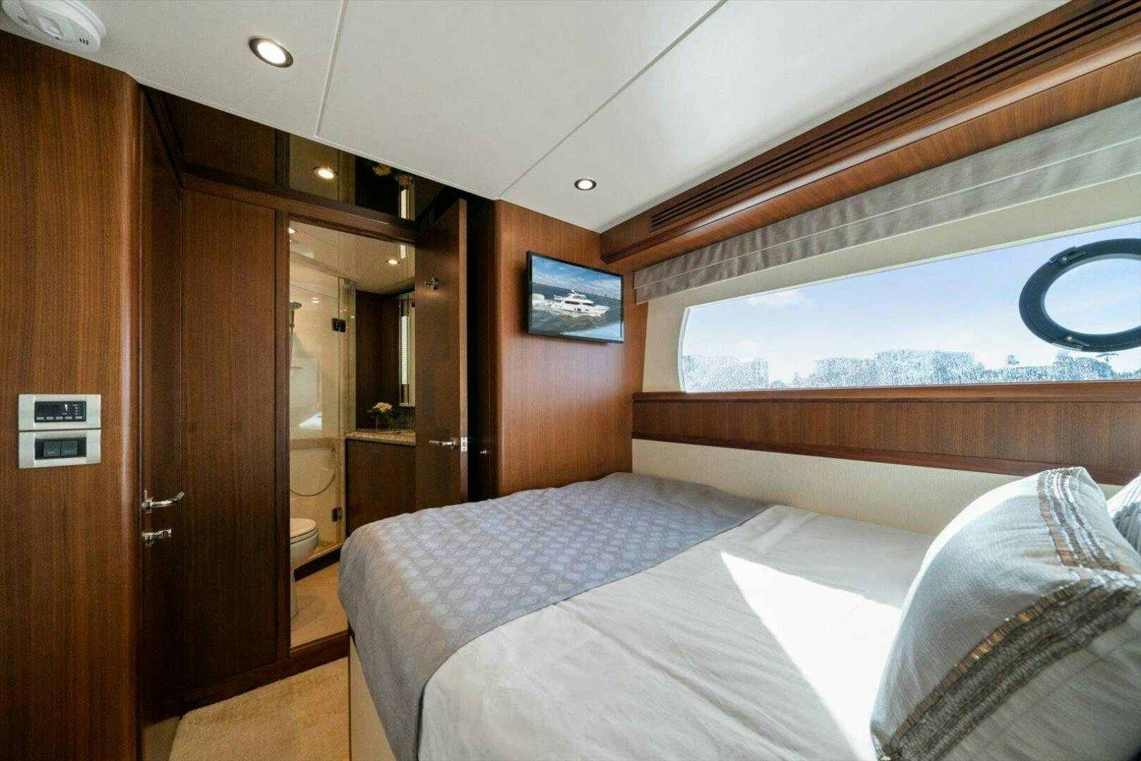 a room with a bed and a television aboard CAROL ELAINE Yacht for Sale