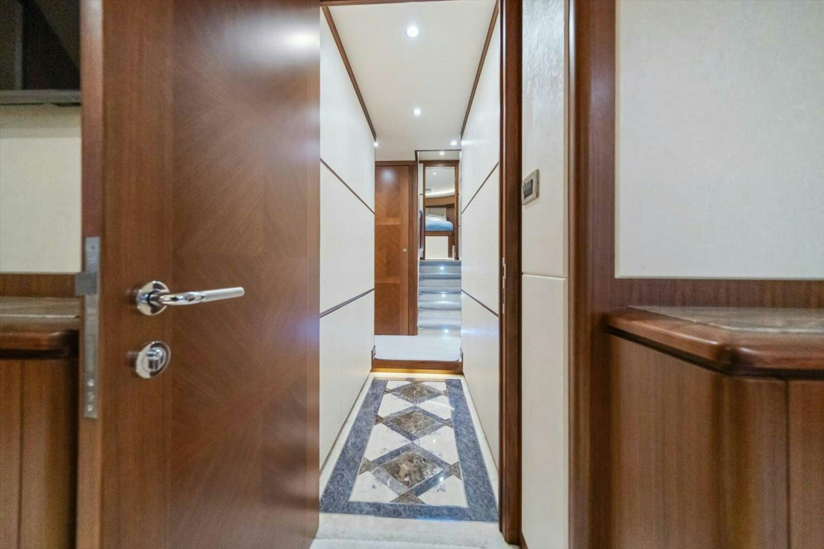 a room with a wood door and a tile floor aboard CAROL ELAINE Yacht for Sale