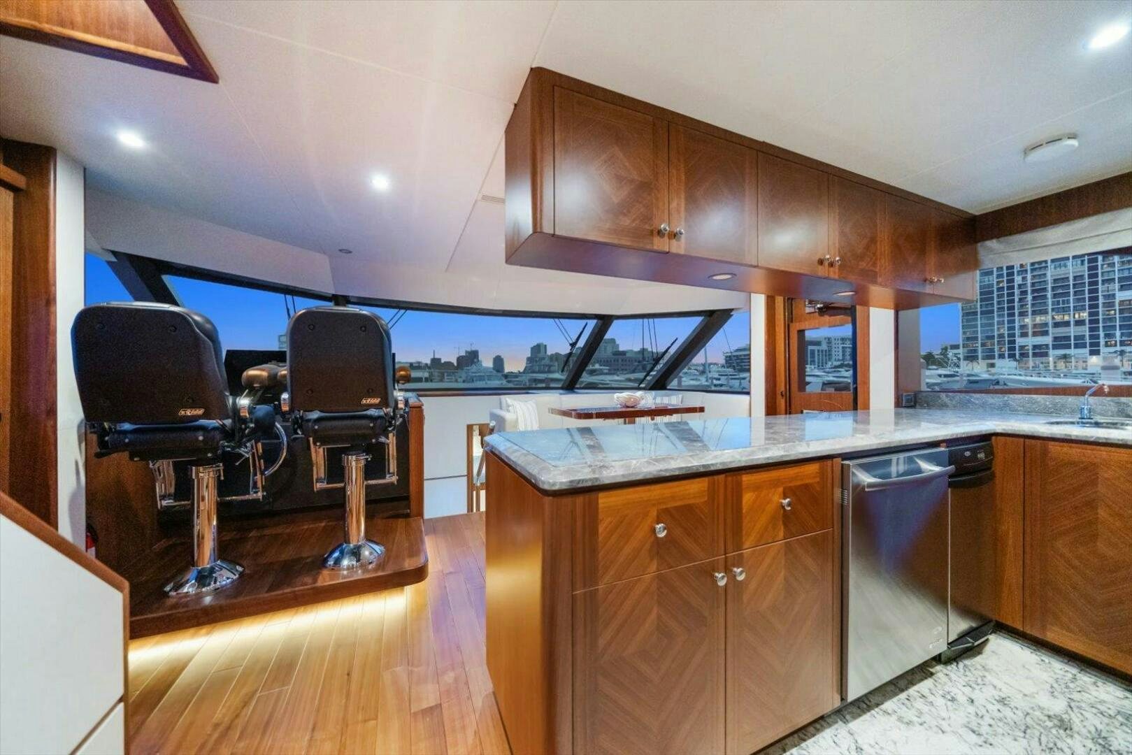 a kitchen with a bar and chairs aboard CAROL ELAINE Yacht for Sale