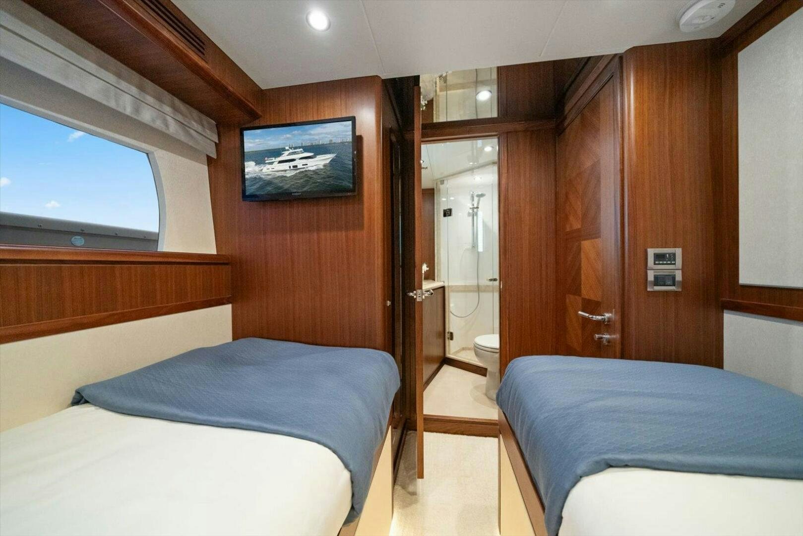 a room with a bed and a television aboard CAROL ELAINE Yacht for Sale