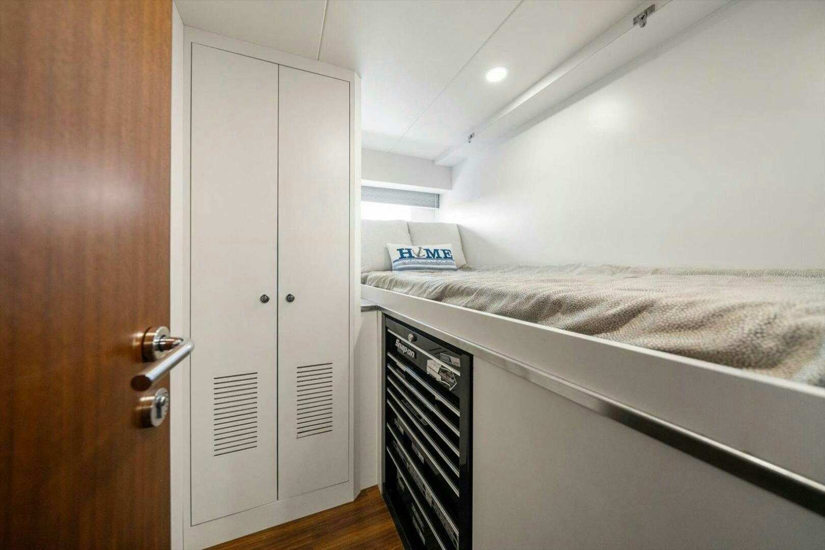 a bedroom with a bed and a closet aboard CAROL ELAINE Yacht for Sale