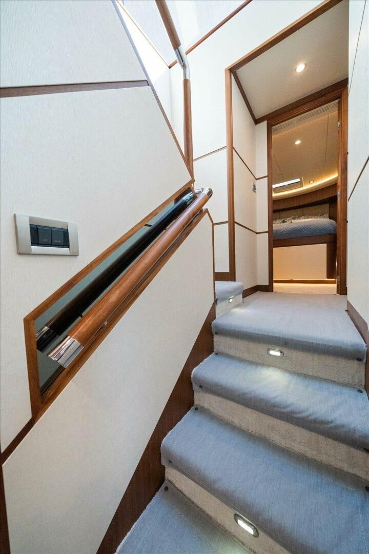 a staircase with a wood railing aboard CAROL ELAINE Yacht for Sale