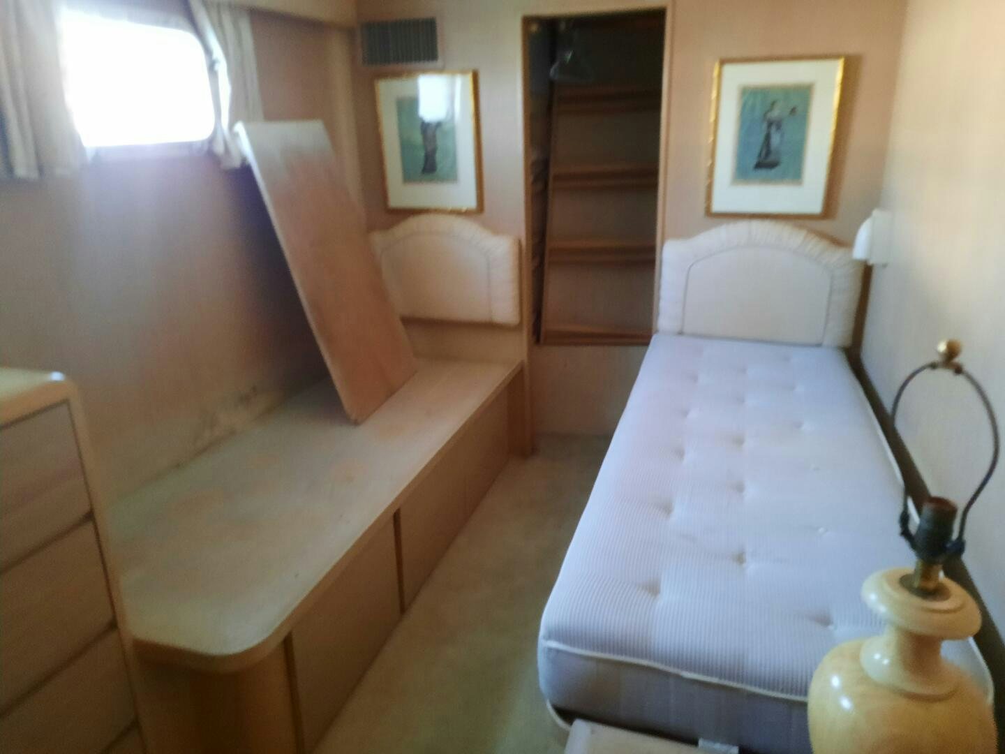 a bed with a white sheet aboard URBAN LEGEND Yacht for Sale