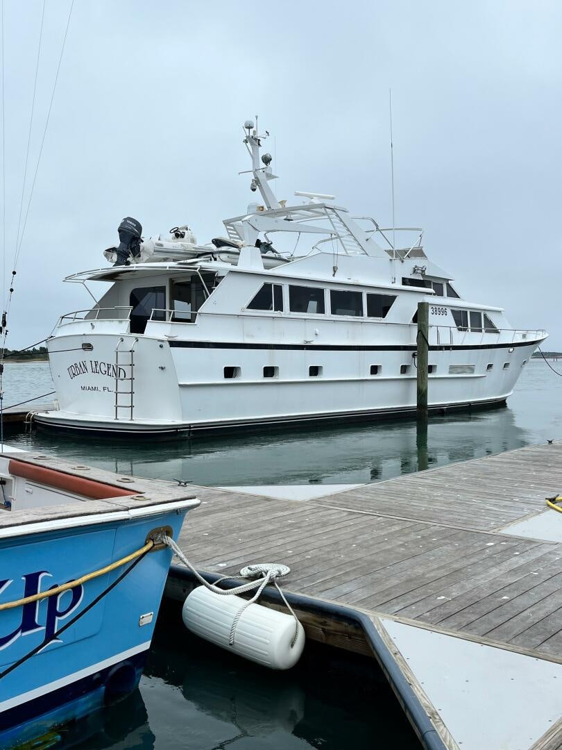 a white boat docked at a pier aboard URBAN LEGEND Yacht for Sale