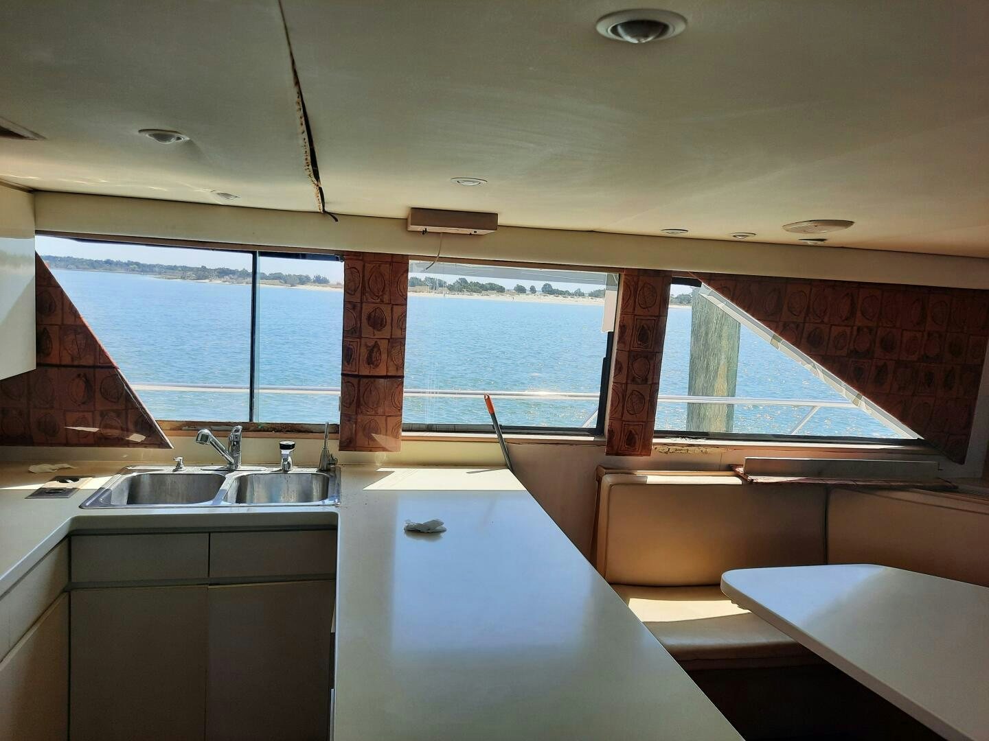 a kitchen with a sink and a window aboard URBAN LEGEND Yacht for Sale