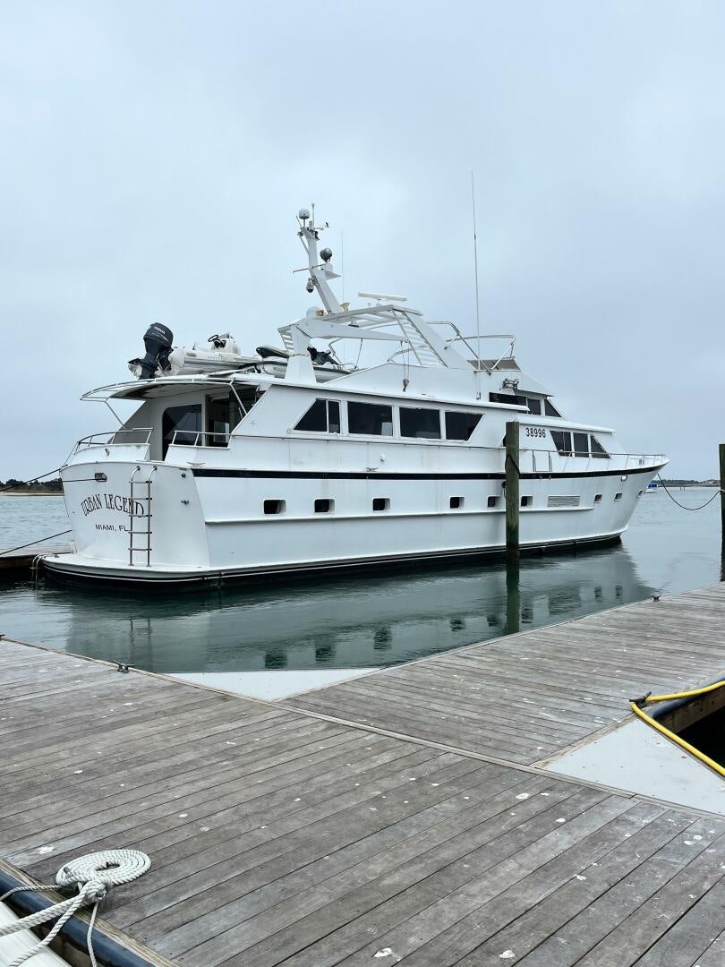 a white boat on a dock aboard URBAN LEGEND Yacht for Sale
