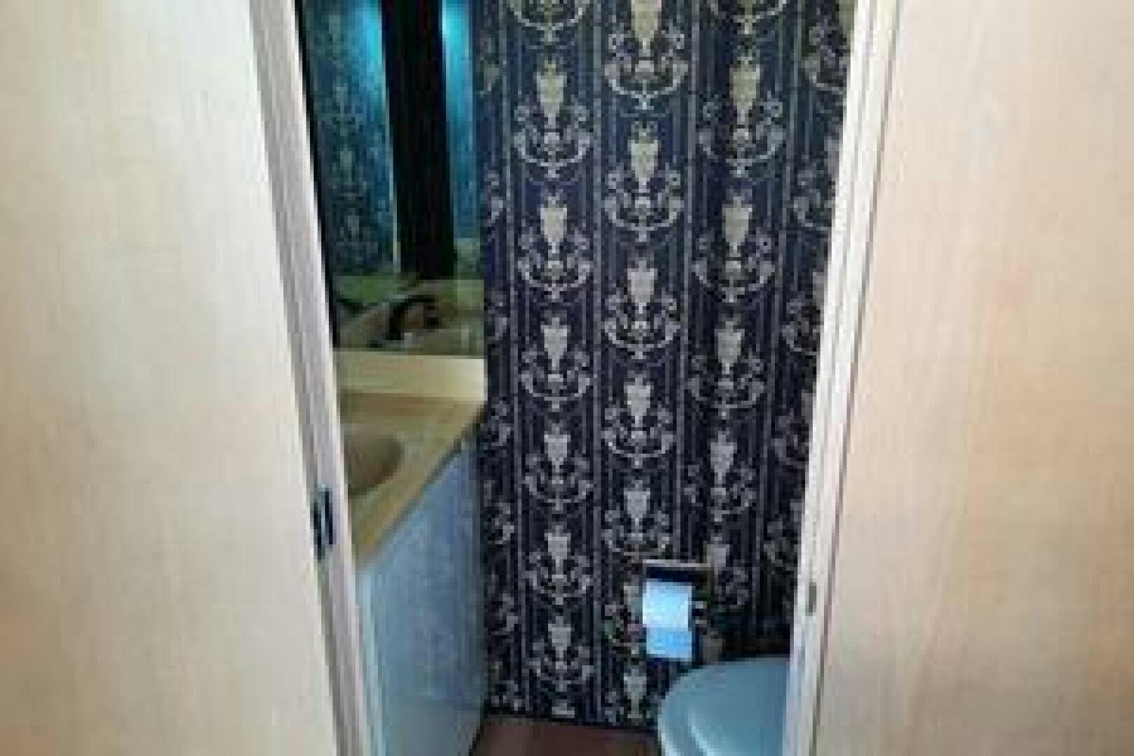 a bathroom with a shower curtain aboard URBAN LEGEND Yacht for Sale