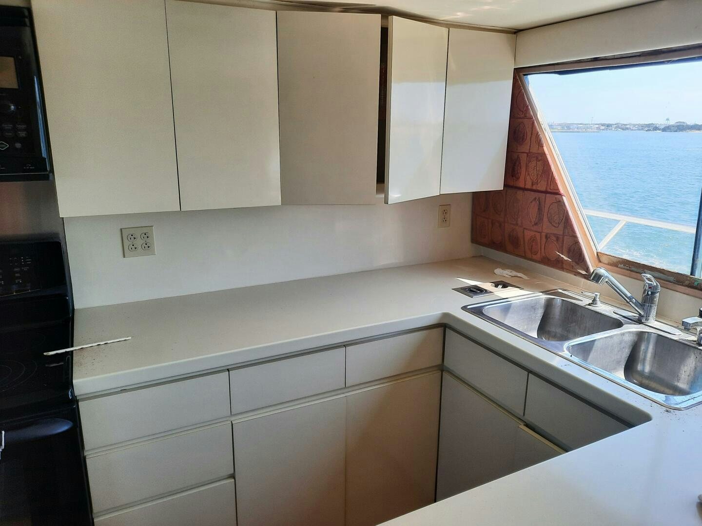 a kitchen with white cabinets aboard URBAN LEGEND Yacht for Sale