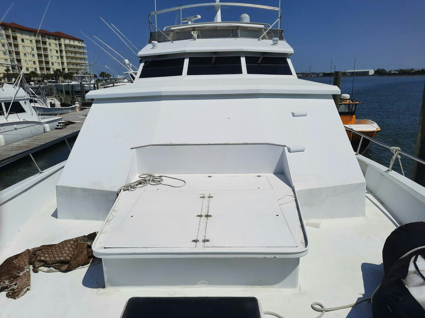 a white yacht in a harbor aboard URBAN LEGEND Yacht for Sale