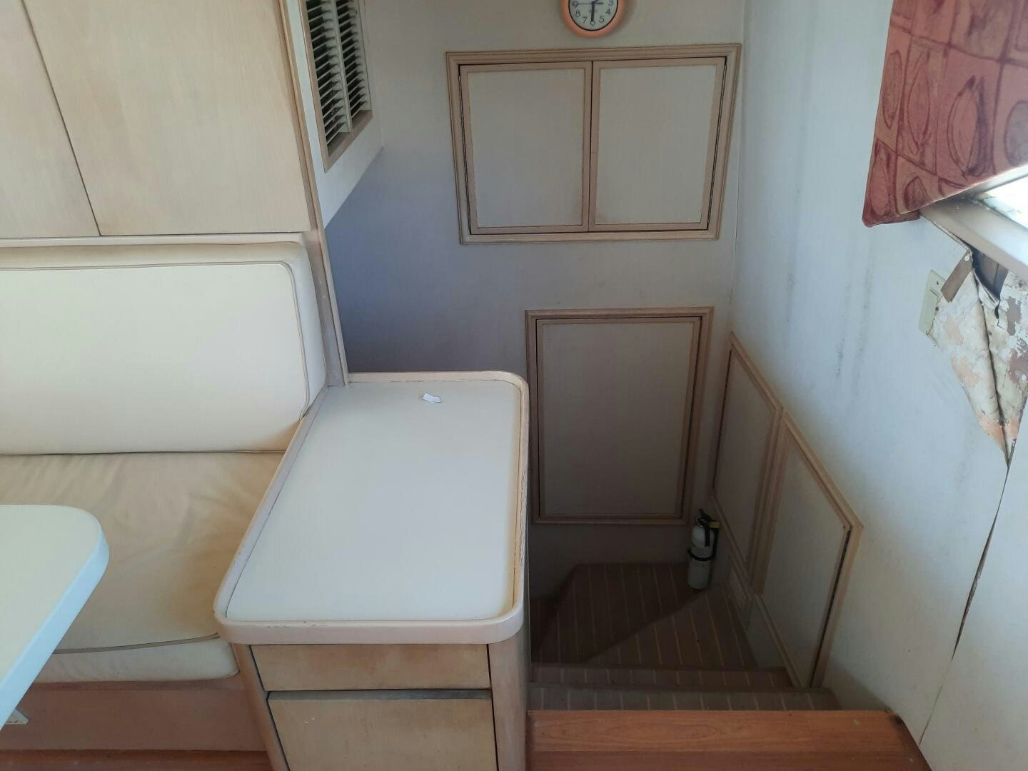 a small room with a toilet and a chair aboard URBAN LEGEND Yacht for Sale