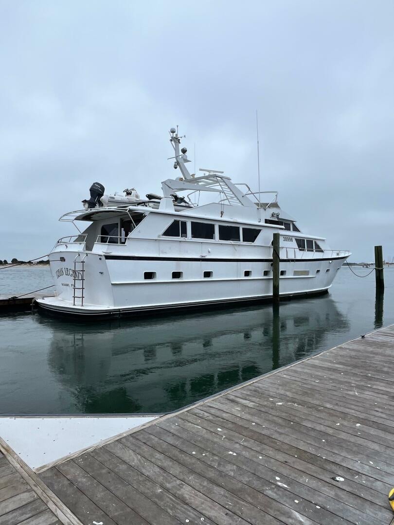 a white boat on a dock aboard URBAN LEGEND Yacht for Sale