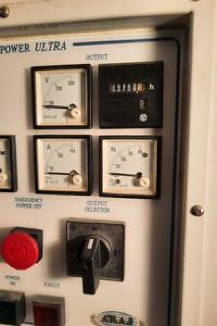 a wall with pictures and a clock aboard URBAN LEGEND Yacht for Sale