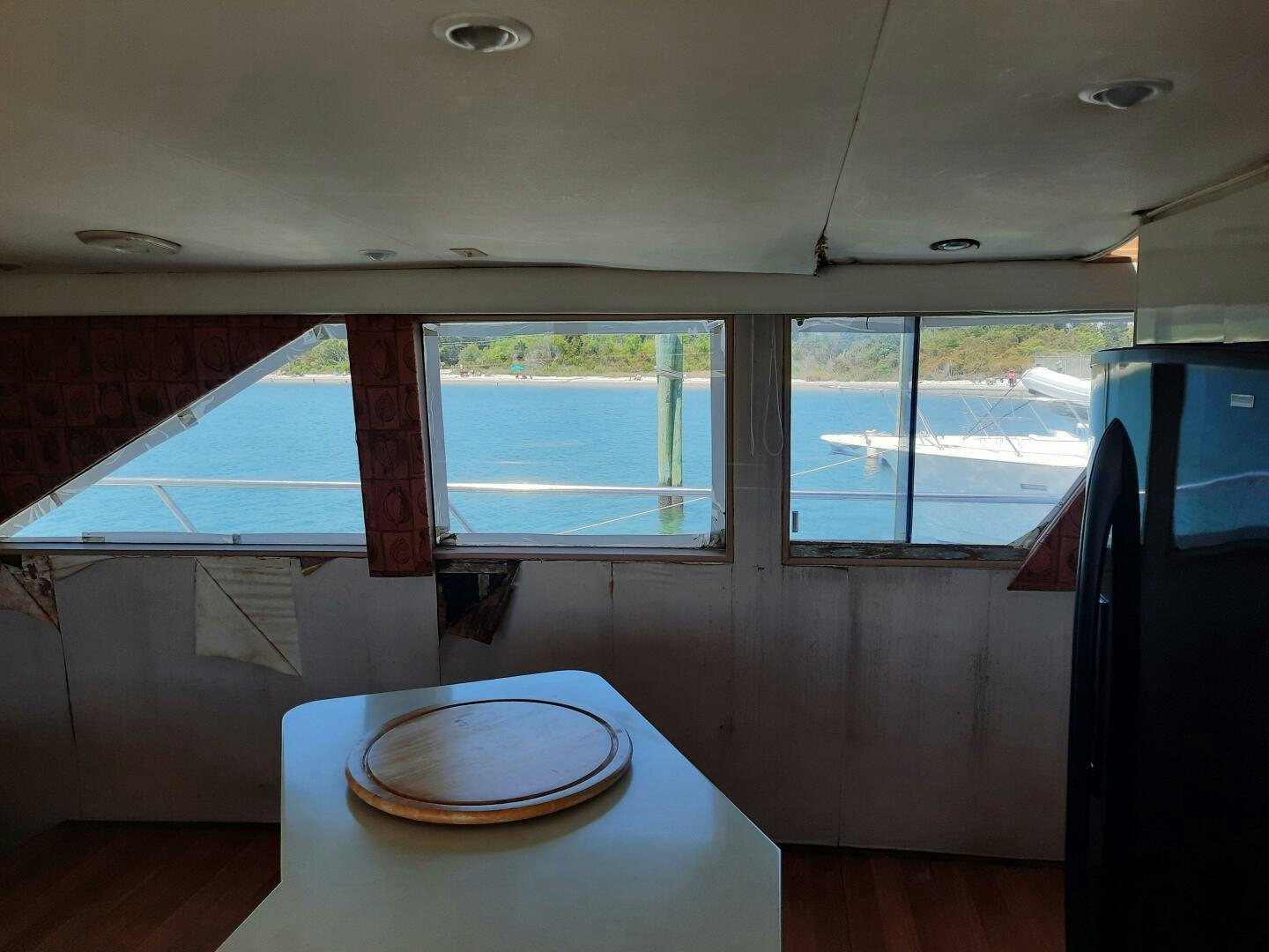 a room with a table and a window aboard URBAN LEGEND Yacht for Sale