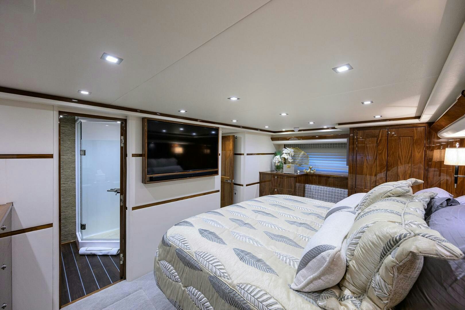 a bedroom with a bed and a television aboard FOR PETE'S SAKE Yacht for Sale