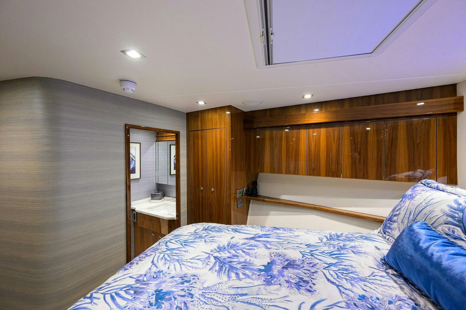 a bedroom with a bed and a mirror aboard FOR PETE'S SAKE Yacht for Sale