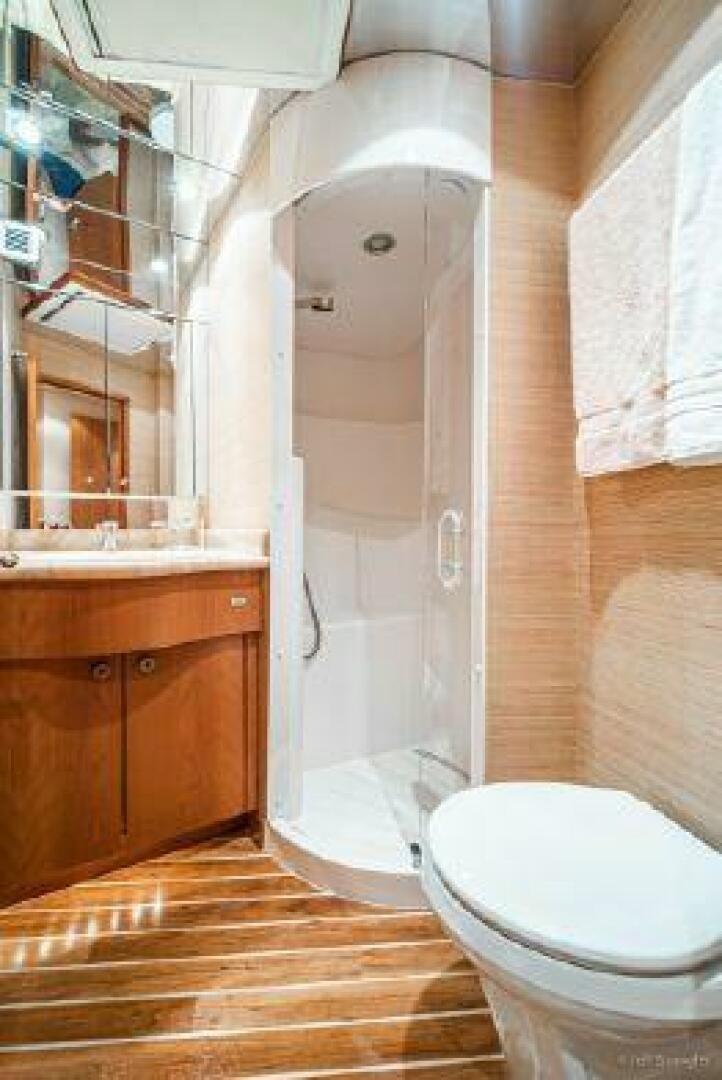 a bathroom with a shower and toilet aboard DESPERADO Yacht for Sale