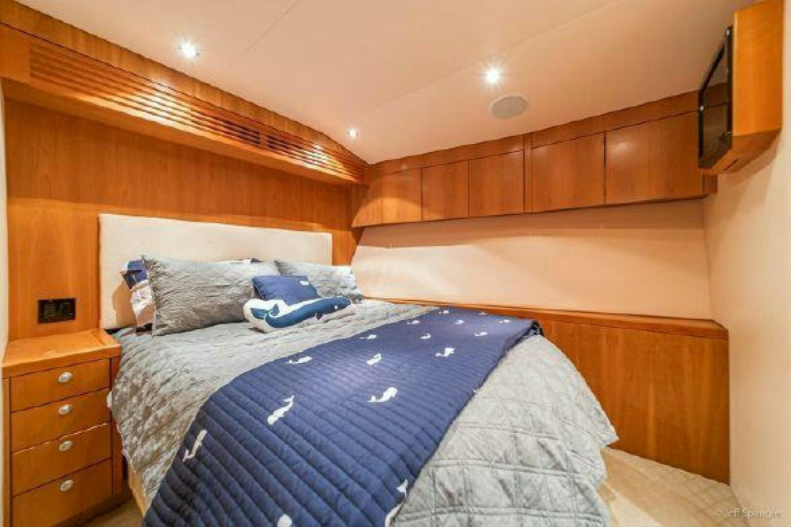 a bed with a blue blanket aboard DESPERADO Yacht for Sale