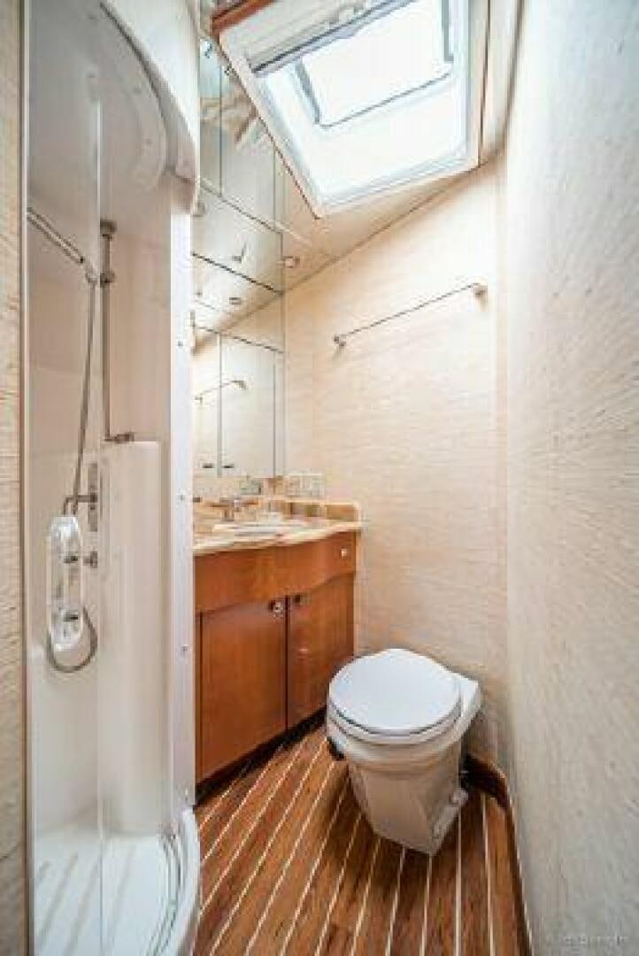 a bathroom with a toilet and a sink aboard DESPERADO Yacht for Sale