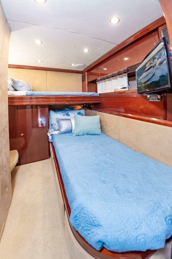 a room with a bed and a television aboard ANDREA'S REVENGE Yacht for Sale