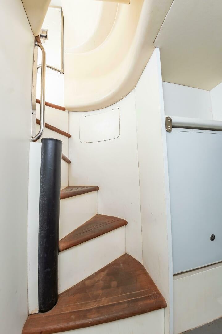 a wooden staircase with a light fixture aboard ANDREA'S REVENGE Yacht for Sale