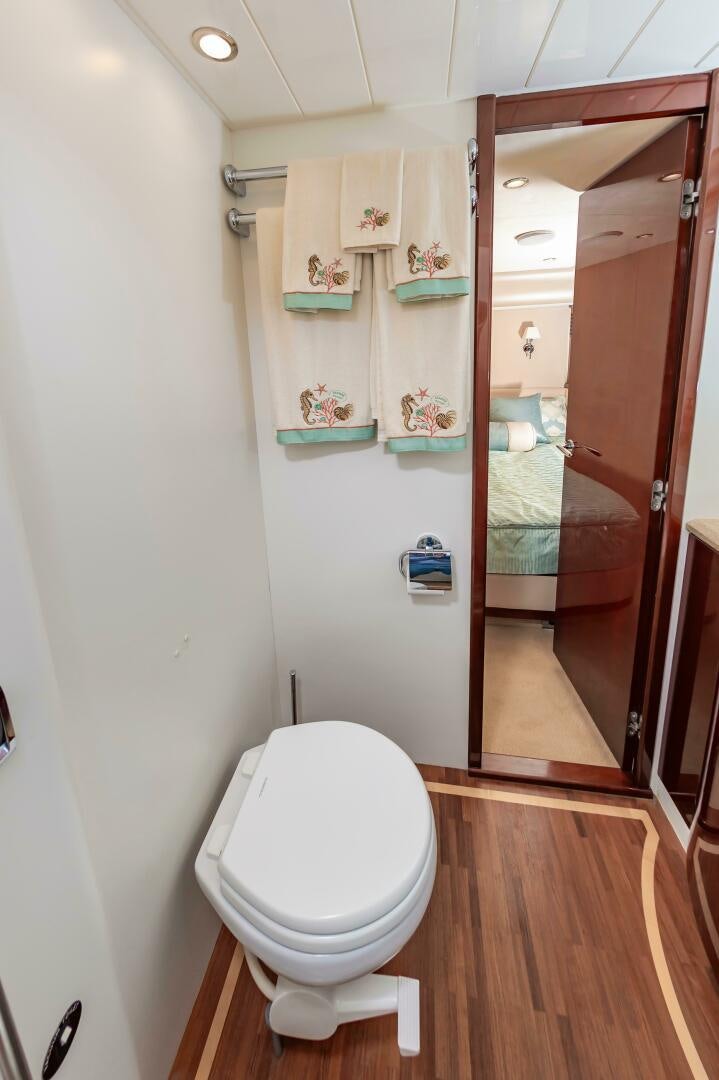 a bathroom with a toilet and a mirror aboard ANDREA'S REVENGE Yacht for Sale