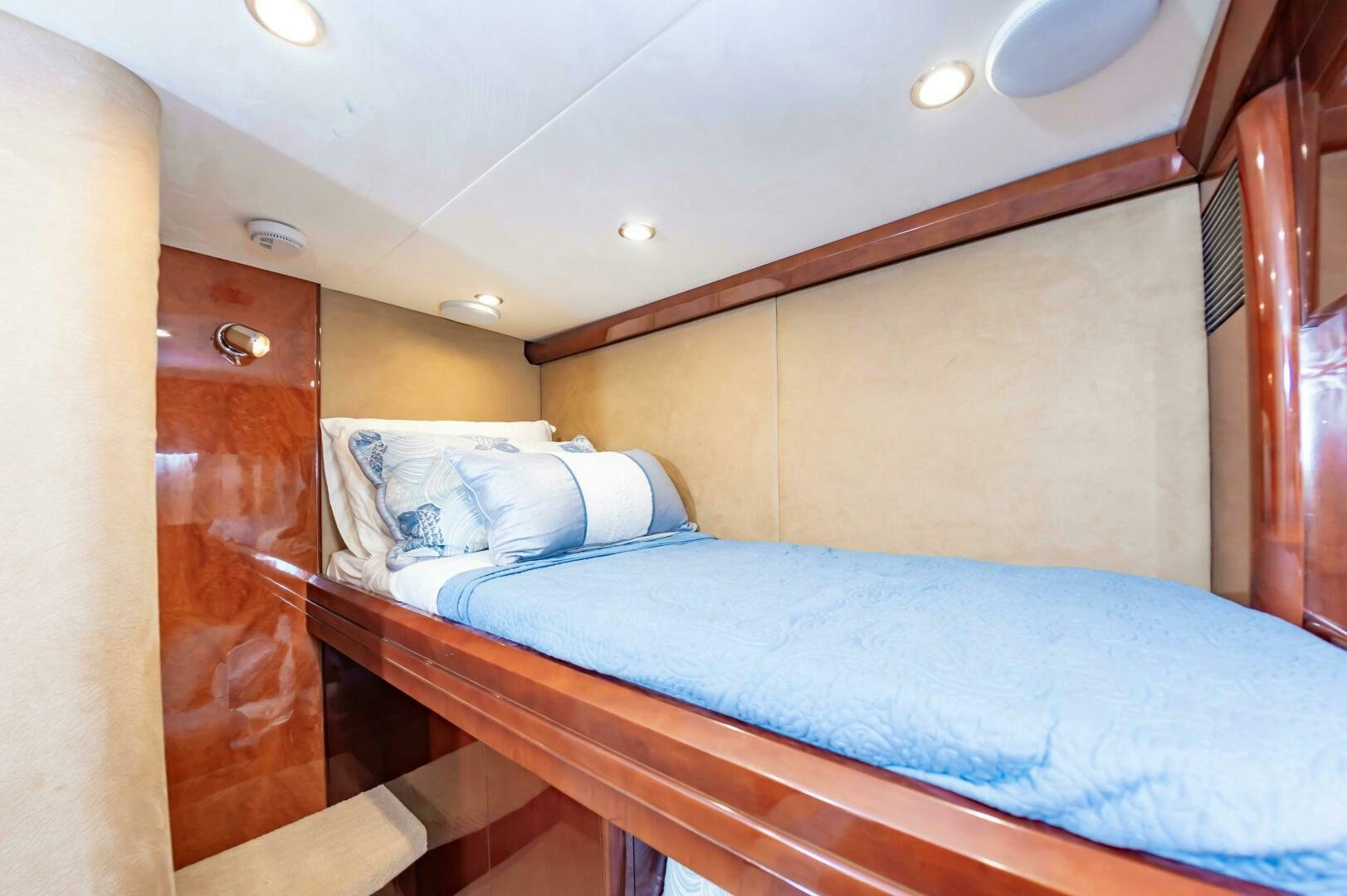 a bed with a blue comforter aboard ANDREA'S REVENGE Yacht for Sale