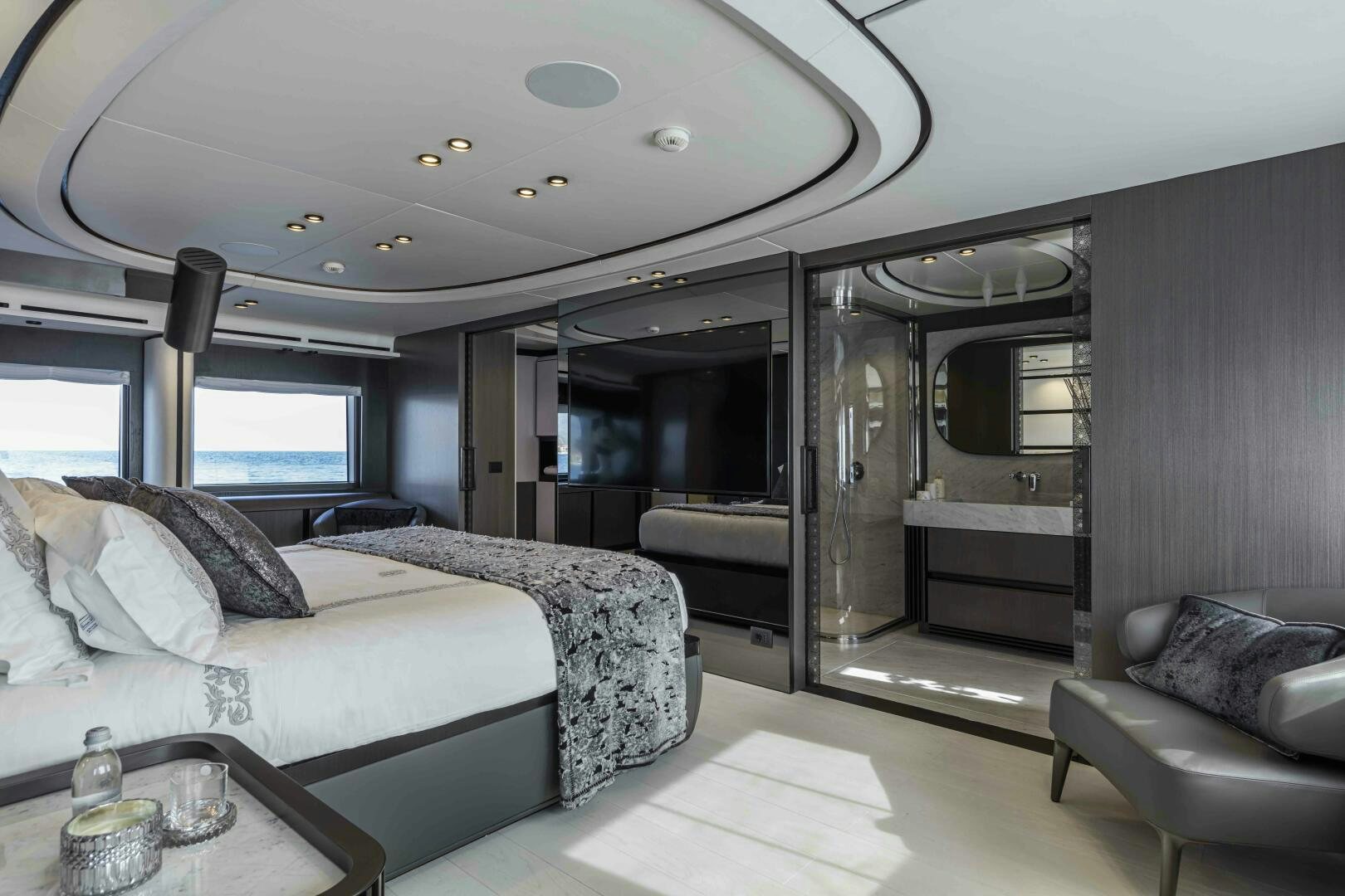 a room with a bed and a couch aboard X130 TRIPLEX Yacht for Sale