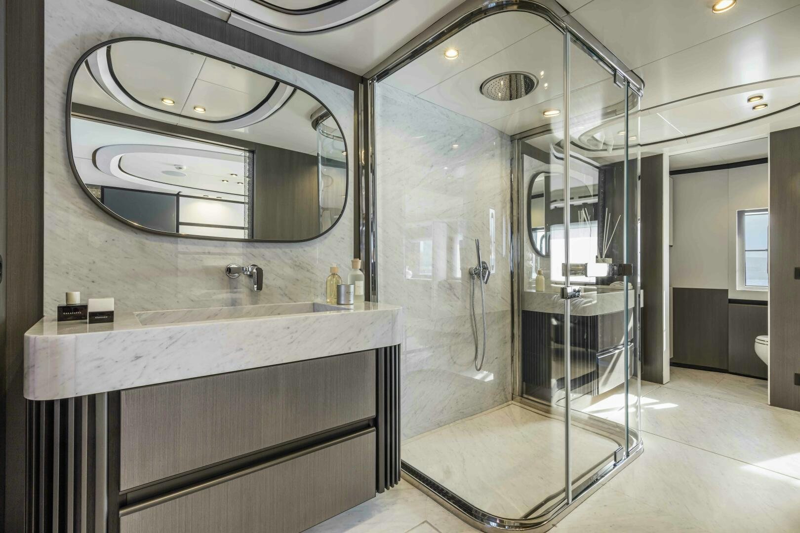 a bathroom with a large mirror aboard X130 TRIPLEX Yacht for Sale