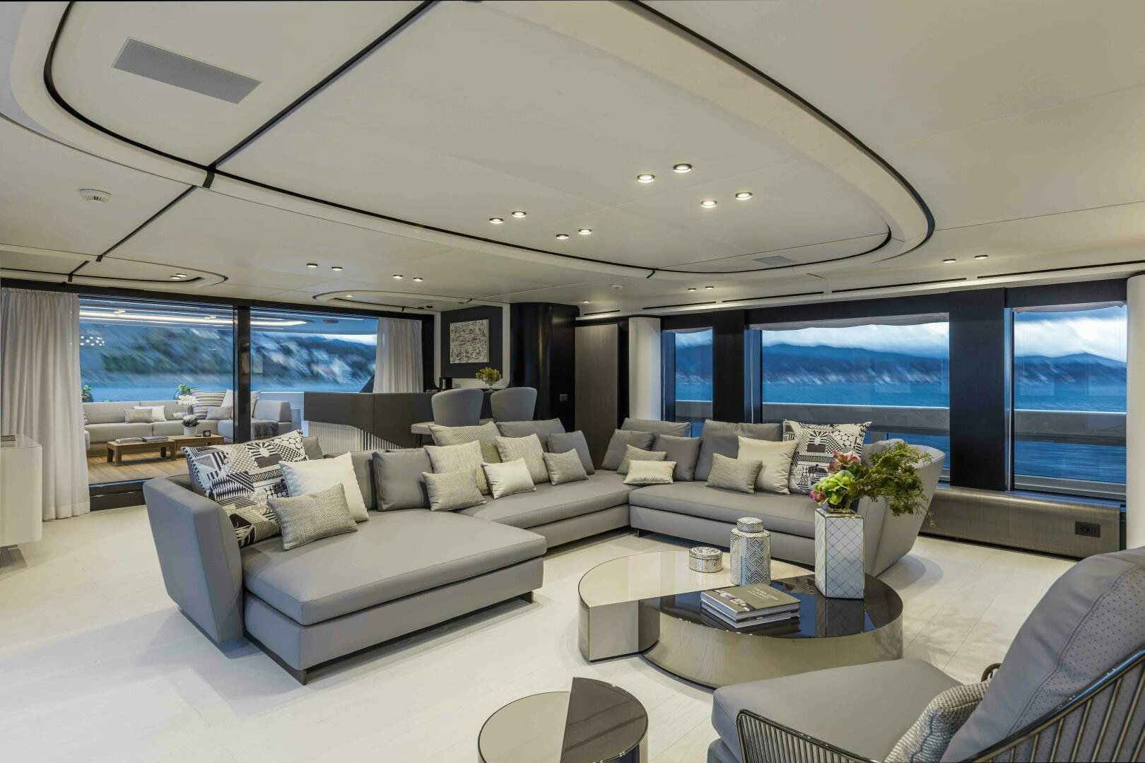 a living room with a large window aboard X130 TRIPLEX Yacht for Sale