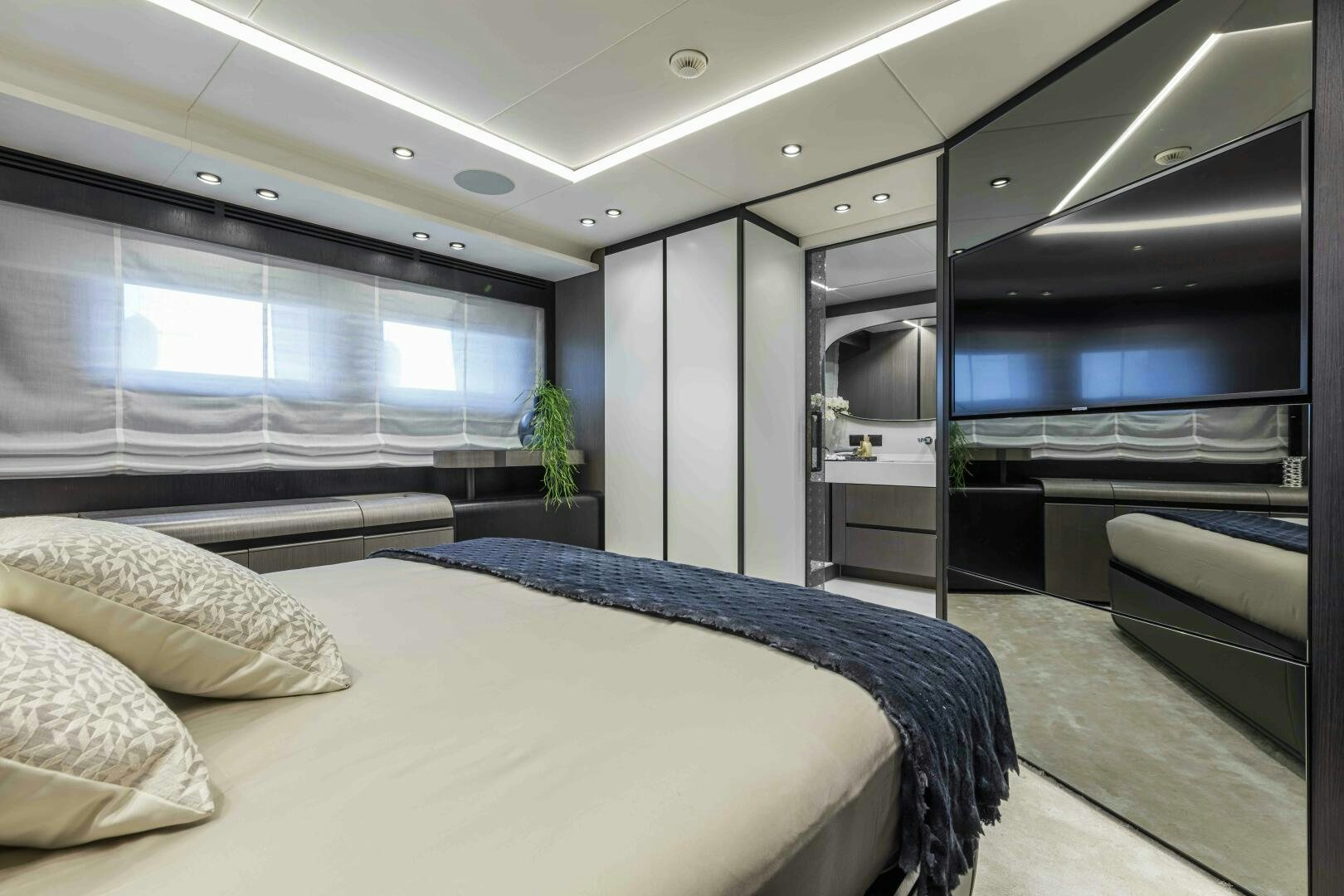 a room with a bed and a television aboard X130 TRIPLEX Yacht for Sale