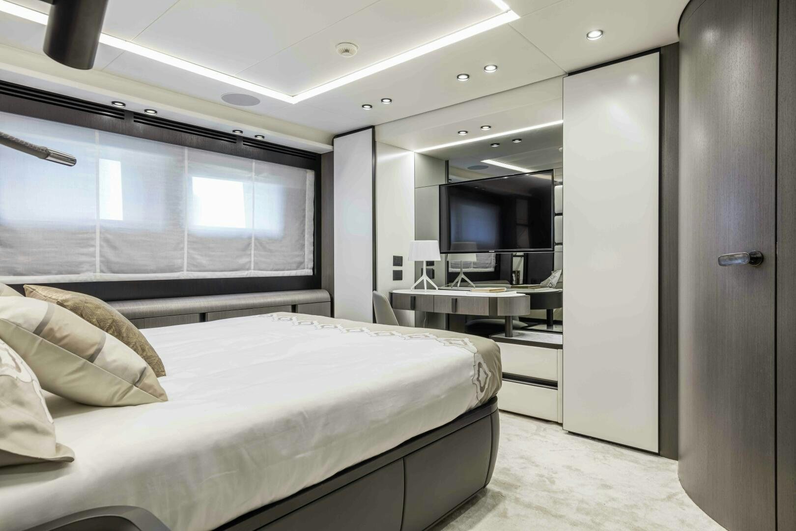 a room with a bed and a television aboard X130 TRIPLEX Yacht for Sale