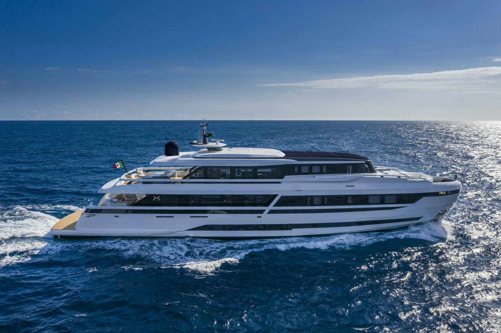 a white yacht in the water aboard X130 TRIPLEX Yacht for Sale