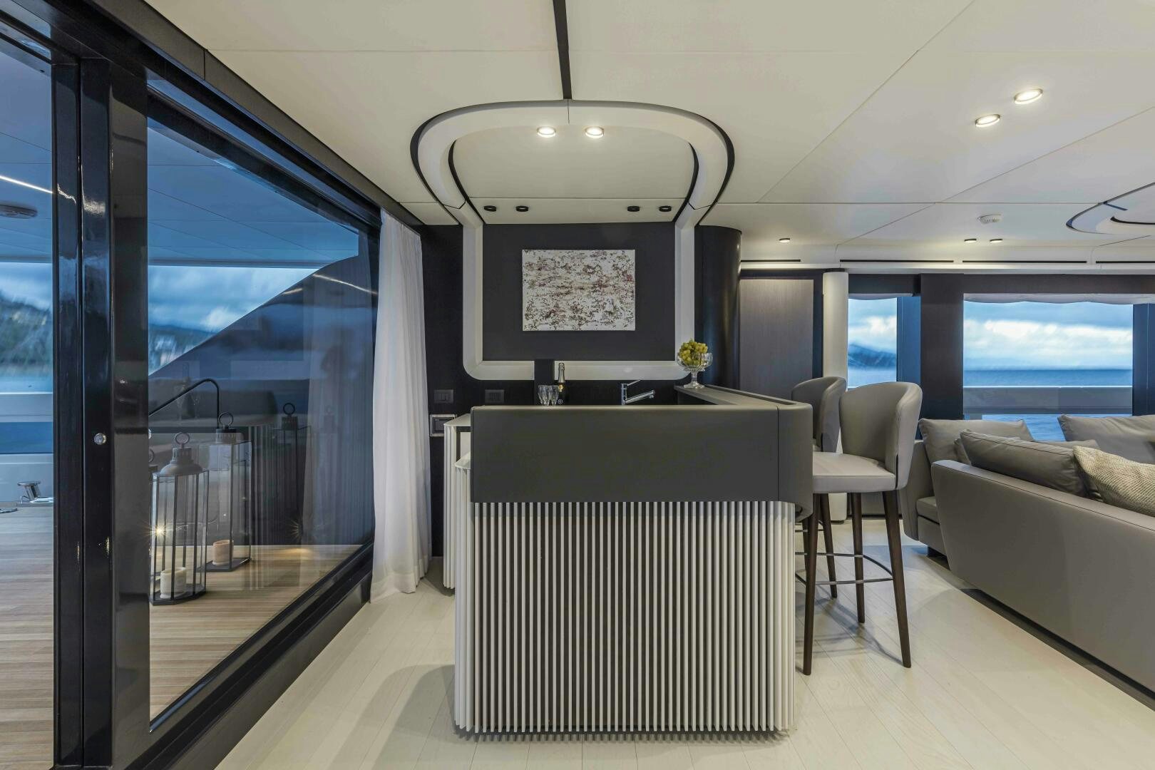 inside of a building with a large window and a table and chairs aboard X130 TRIPLEX Yacht for Sale