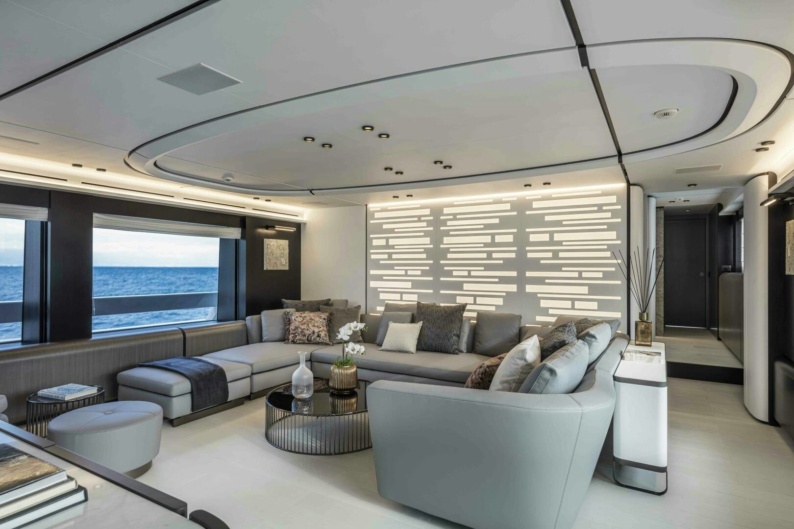 a living room with a large window aboard X130 TRIPLEX Yacht for Sale