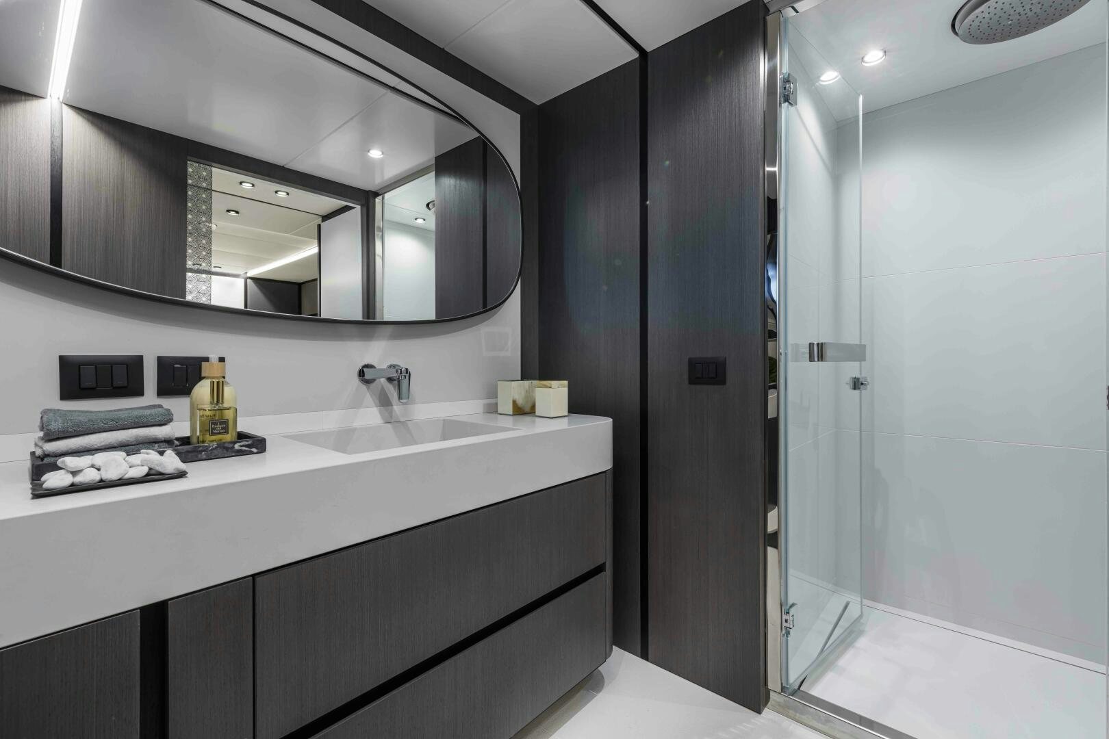 a bathroom with a large mirror aboard X130 TRIPLEX Yacht for Sale