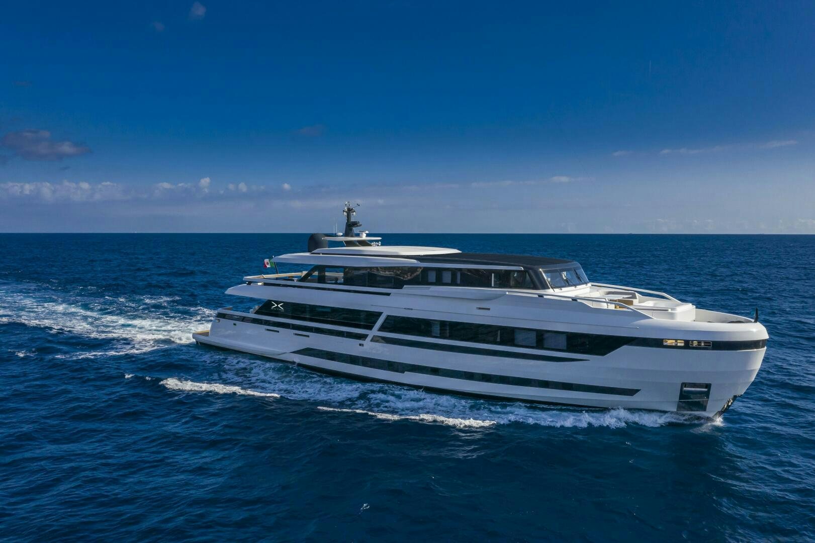 a white yacht in the water aboard X130 TRIPLEX Yacht for Sale