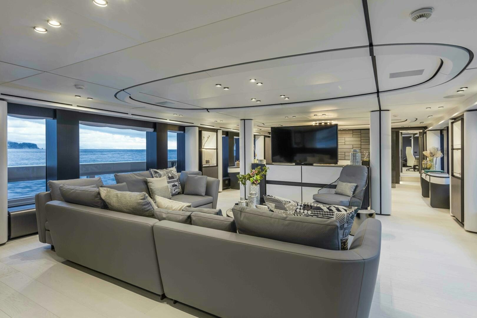a living room with a large window aboard X130 TRIPLEX Yacht for Sale